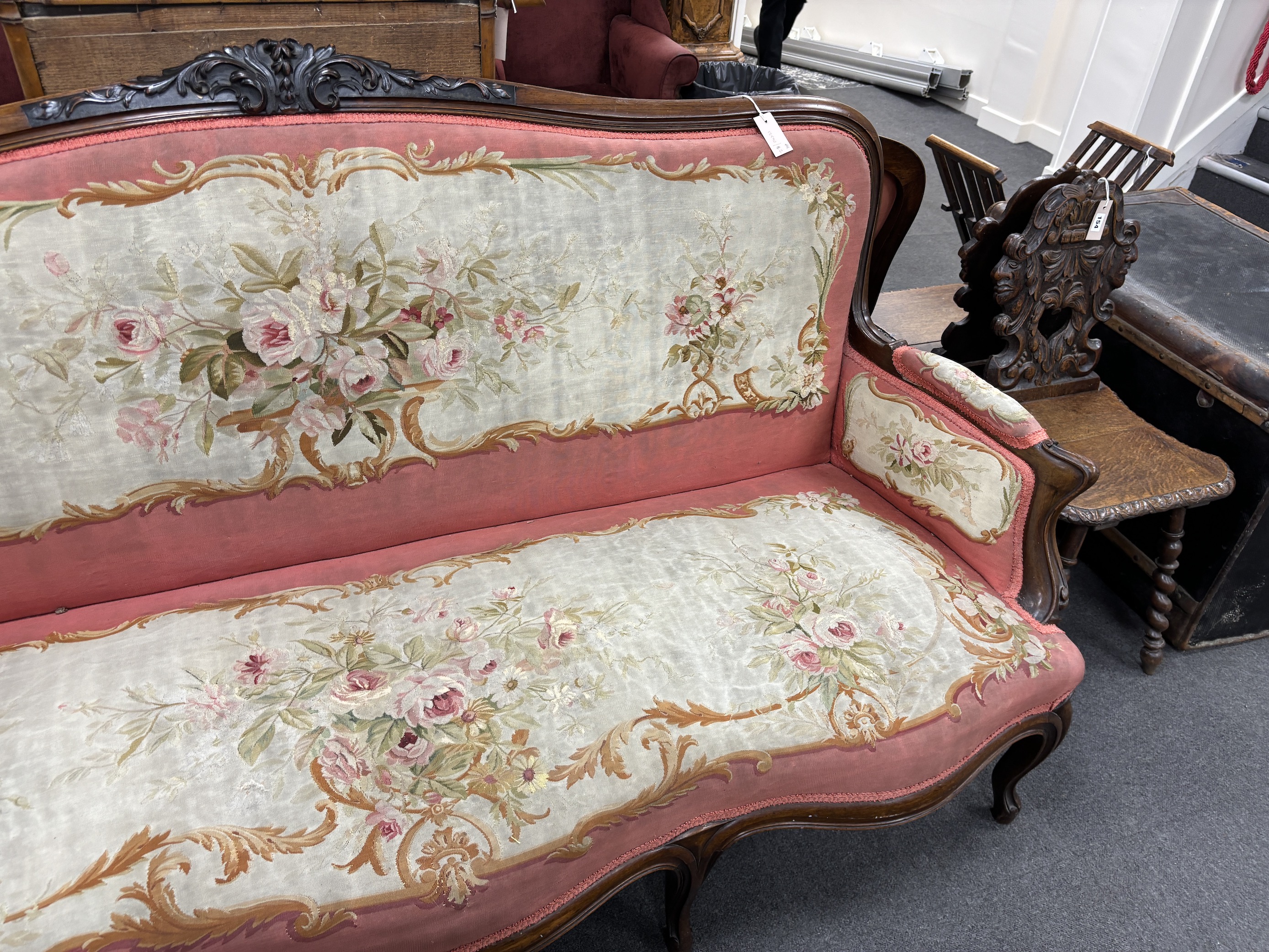 A 19th century French rosewood settee with floral needlepoint upholstery, width 198cm, depth 66cm, height 108cm